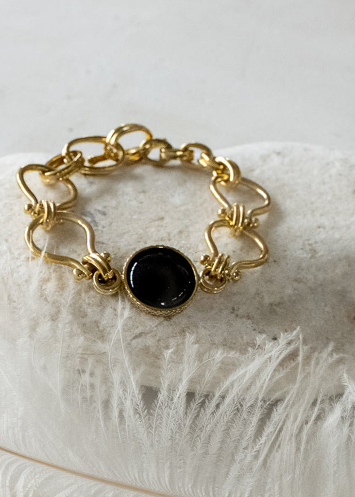 Gold, handmade link bracelet with an encased, center, black onyx stone
