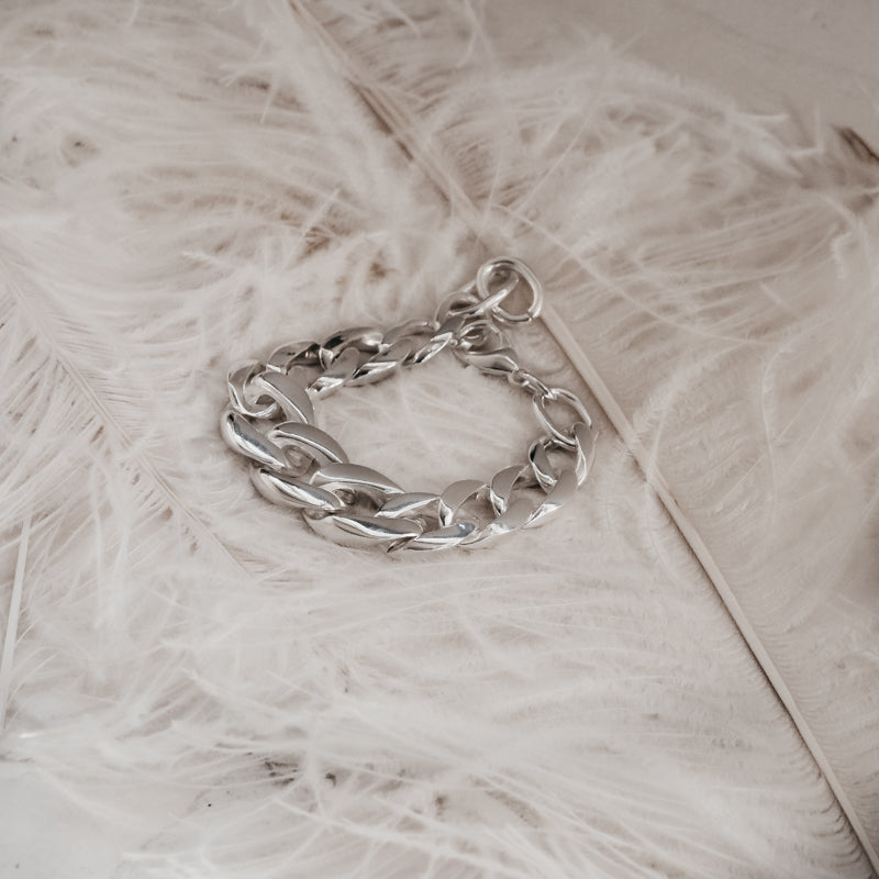 Mangata. Chunky chain bracelet, placed on white feather. By 3rd Floor Handmade Jewellery