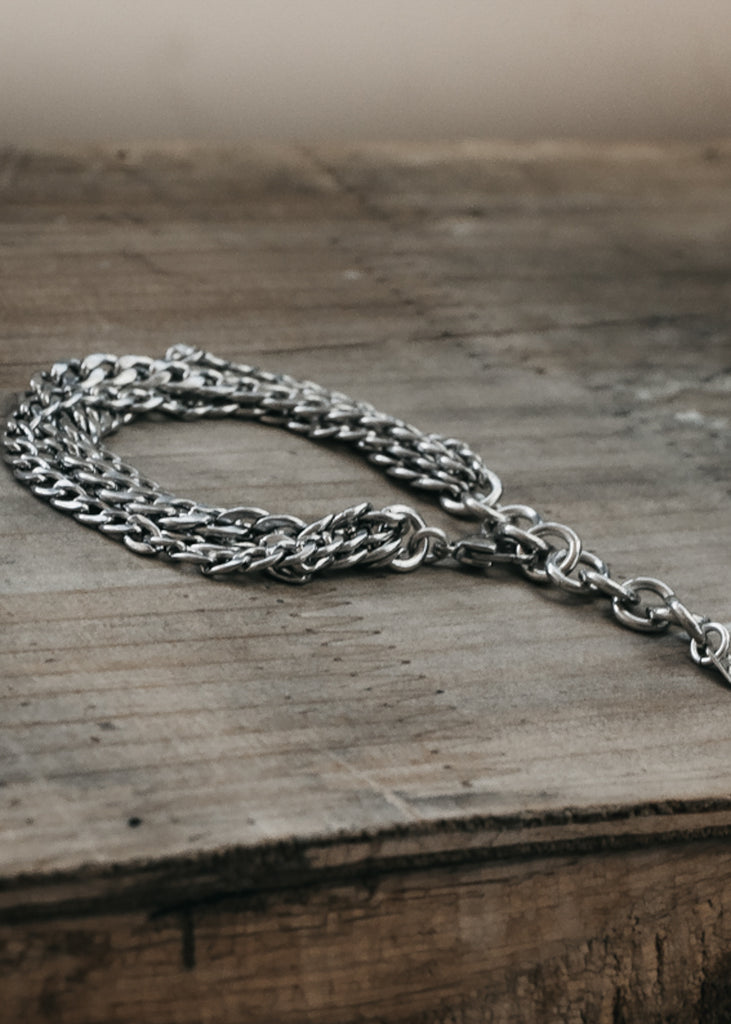 Monsoon. Silver, chunky chain bracelet, placed on a wooden table
