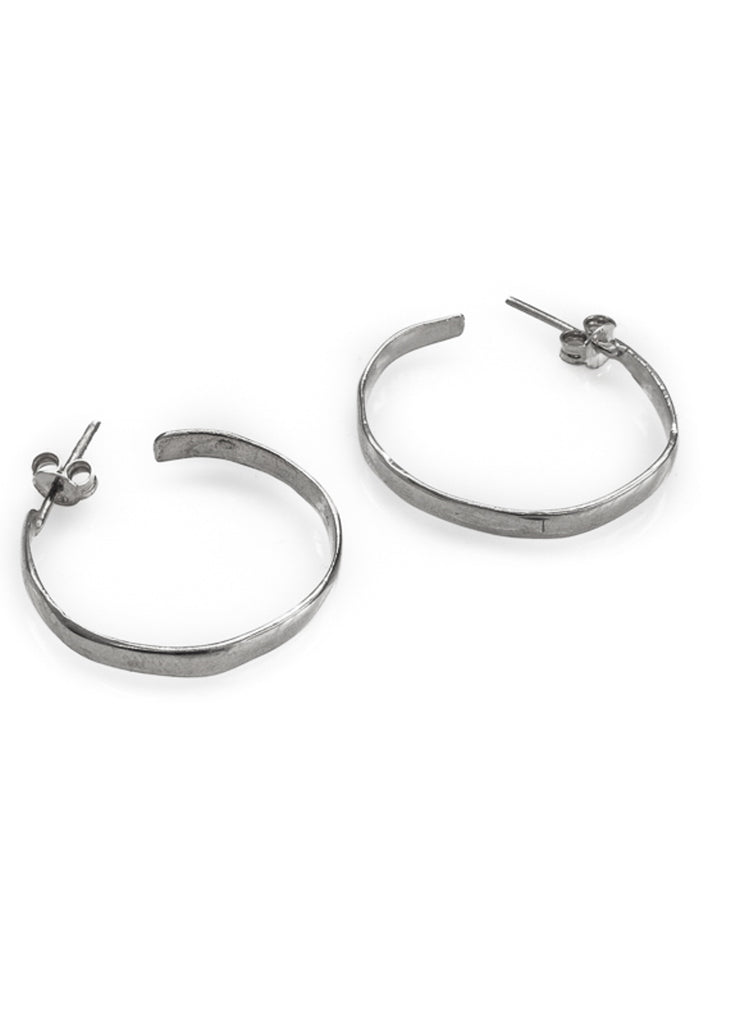 Pair of silver, flat, loop earrings on a completely white background
