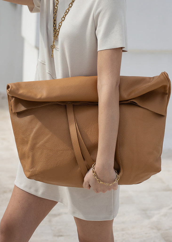 girl in white short dress holding, a 3rd-floor handmade leather, giant bag sand color