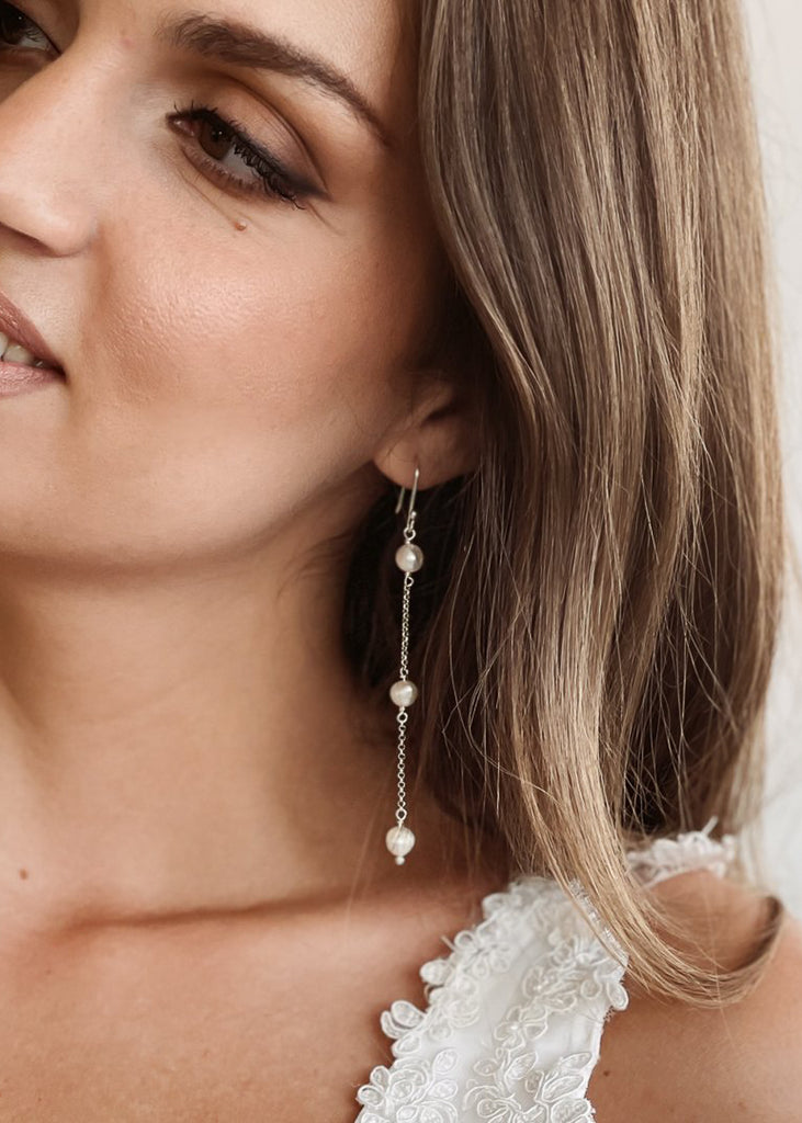 left profile of a brunette wearing the Timeless earring in silver color