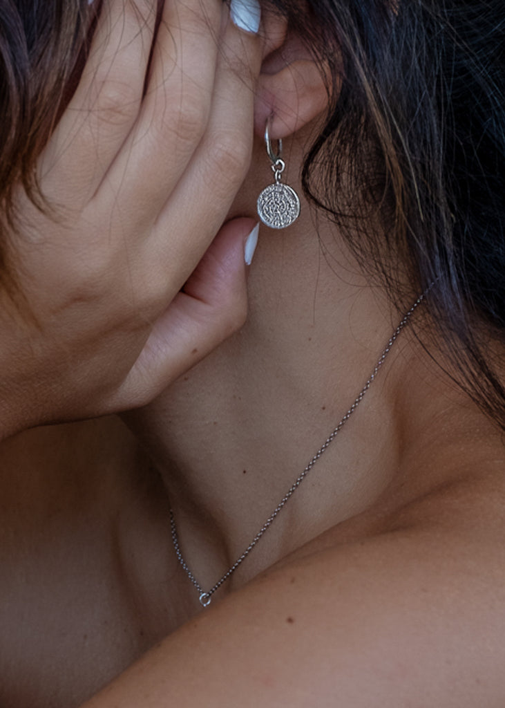 Girl wearing Phaistos small silver hoop coin earrings by 3rd Floor Handmade Jewellery
