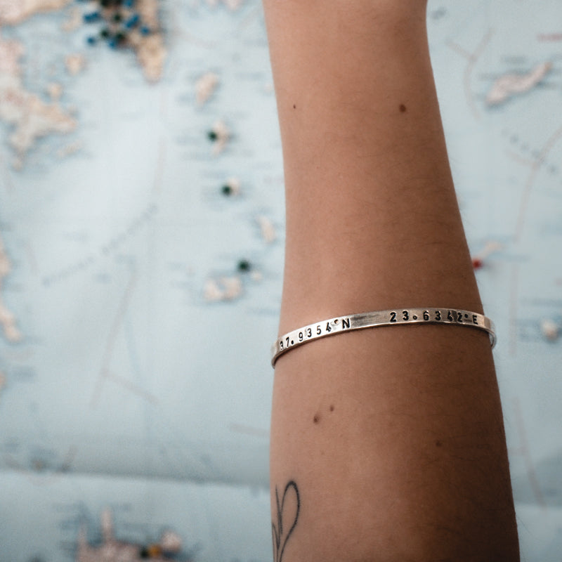 womans arm, with coordinates bracelet memories,silver