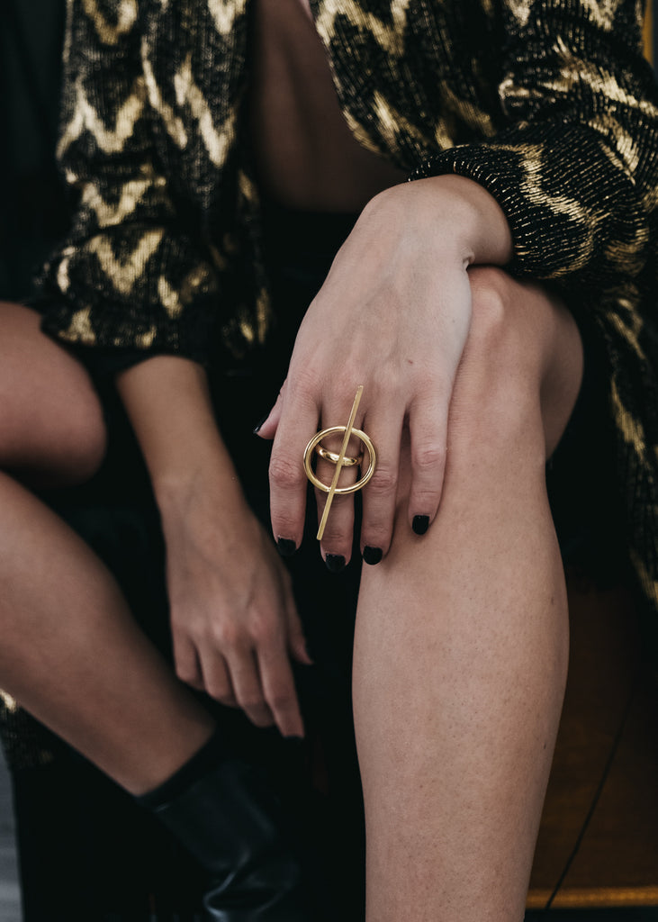 Close up of woman hand, wearing a big, gold, ring 