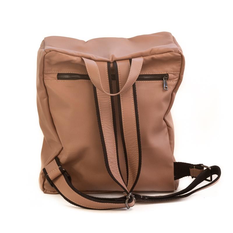 Photo of the back side, of a tan colored backpack