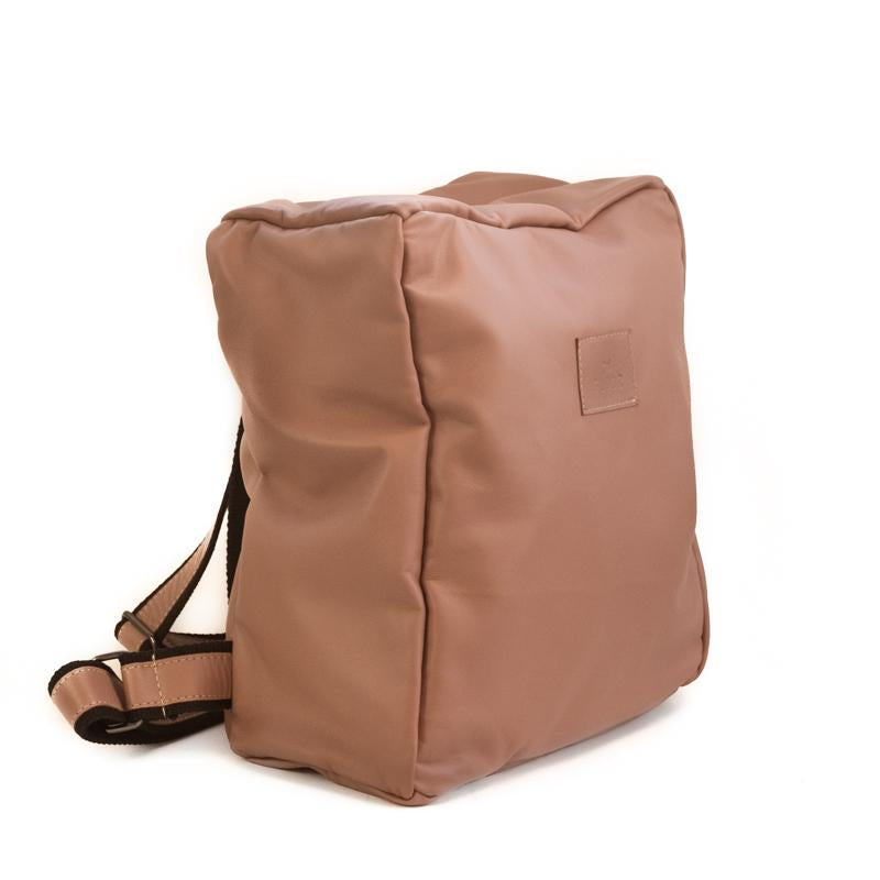 Photo of front side of a ligh- tan colored backpack
