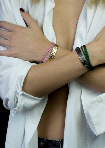 girl's hands crossed over chest open white shirt wearing coordinates stamped bracelets on either wrist