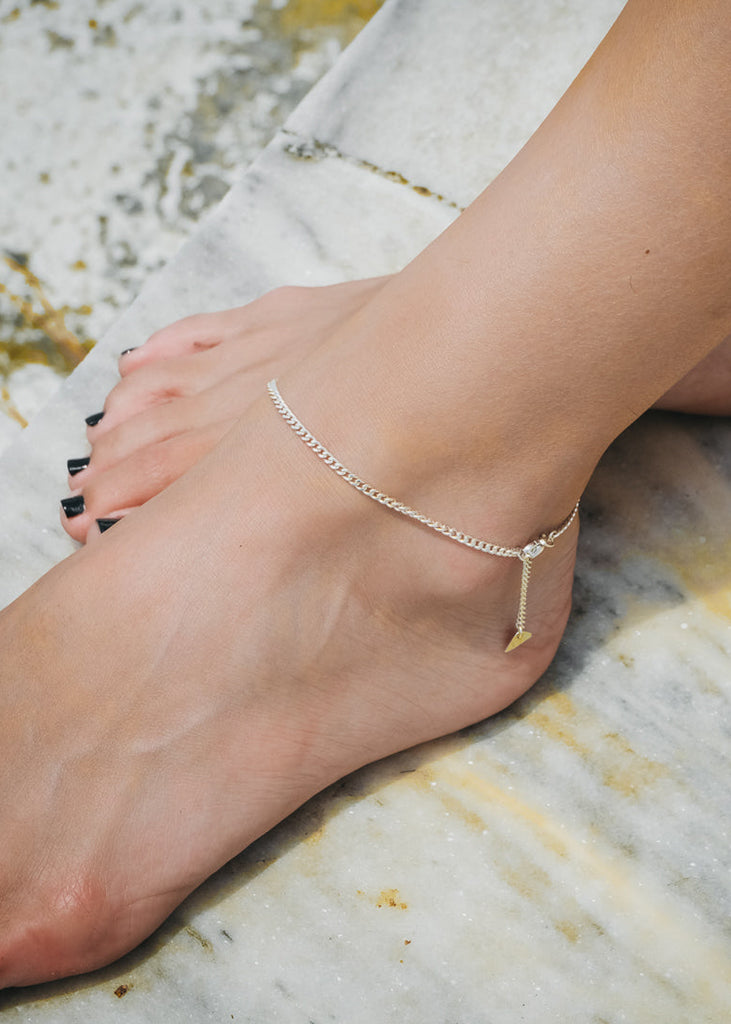 Close up of female's ankle, wearing a thin, silver, anklet by 3rd Floor Lab