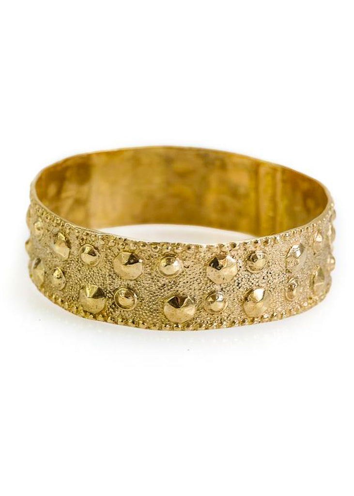 Elizabeth. Gold, wide, bangle bracelet, with protruding, spike-like dots. By 3rd Floor Handmade Jewellery 