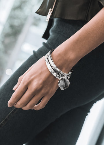 female close-up, with Coordinates handmade bracelets stamped with the longitude and latitude coordinates of your choice 3rd Floor Coordinates Line