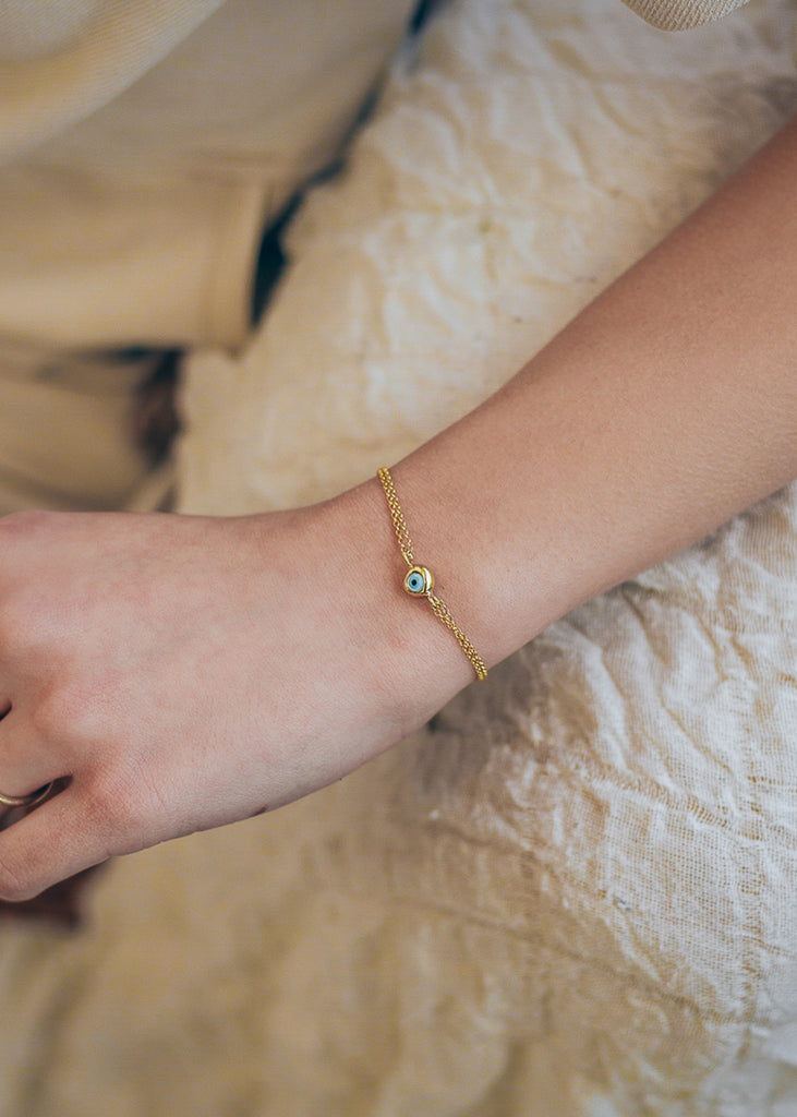  woman's hand with mataki bracelet, gold
