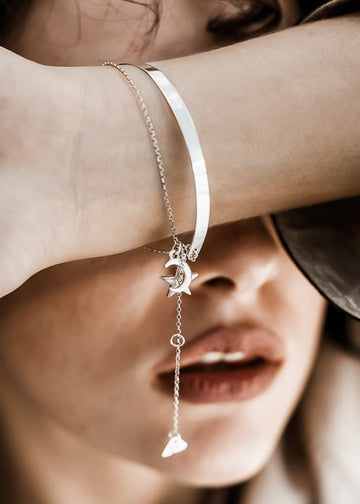 girl wearing handmade, silver plated silver, star and moon charm, bracelet