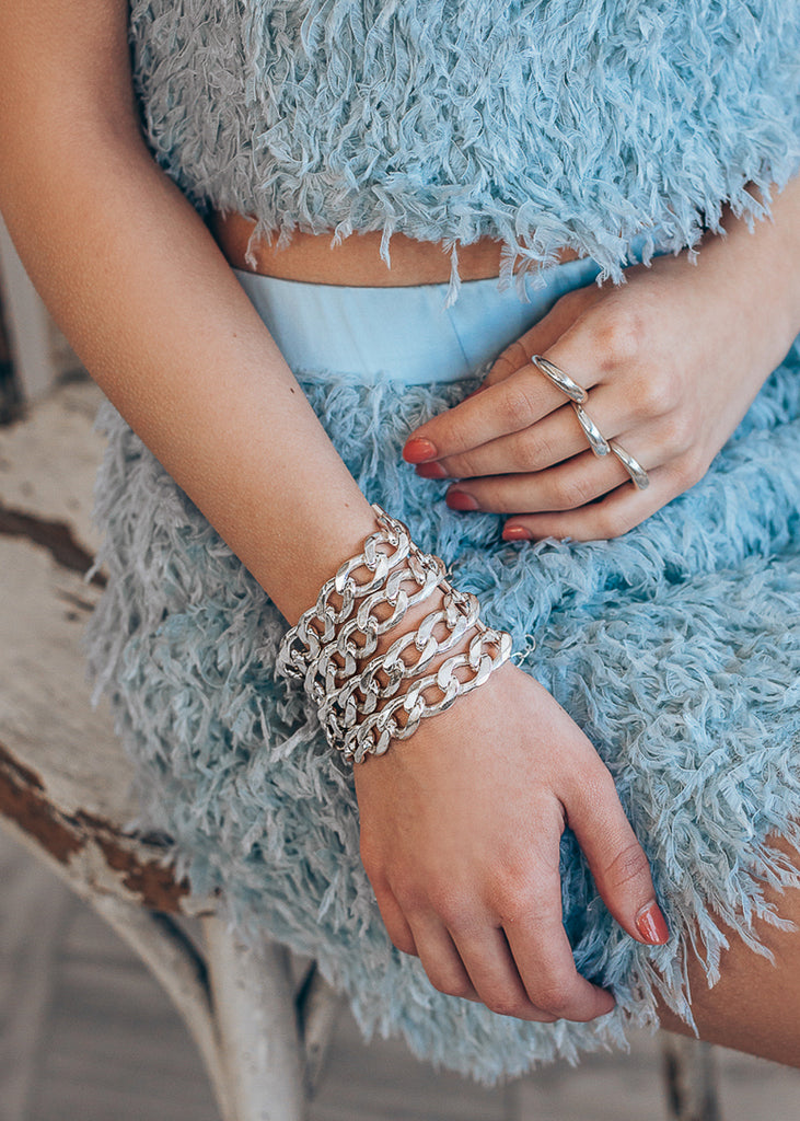 model's hands, she is wearing a Tetra, handmade, silver plated brass, chain bracelet.