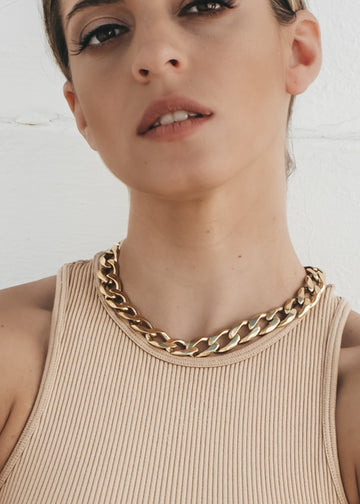 Shot of a woman's head/neck with Bilboe gold necklace. Handmade in Athens
