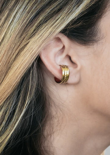 Close up of blond female's right ear. She is wearing an Elora, gold earcuff by 3rd Floor Handmade Jewellery