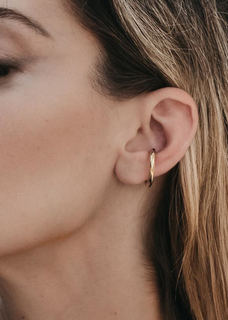 close-up woman, with remy ear-cuff, gold