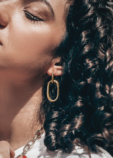 close up woman with 3rd-floor-handmade gold-earrings massive  