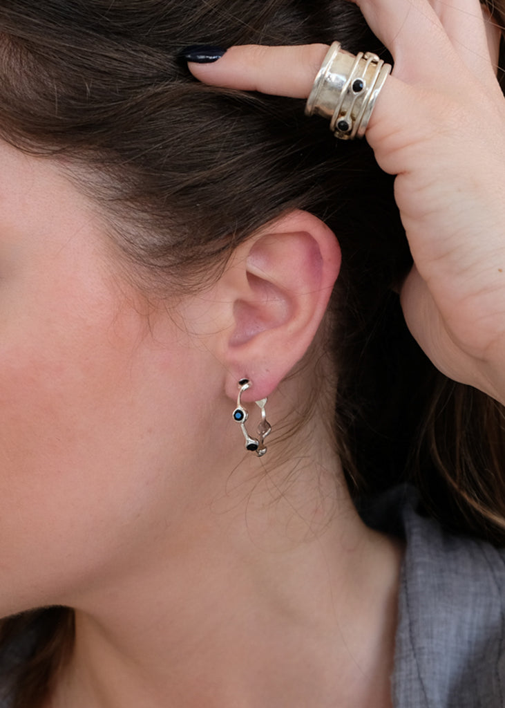 woman wearing 3rd-floor handmade berlin earrings with black stone
