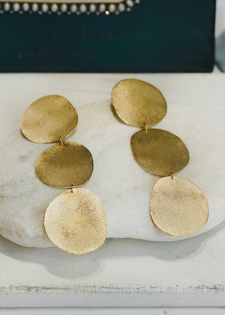 Gold, pendant earrings consisting of three round discs, held together with a small, loosely fitted, link