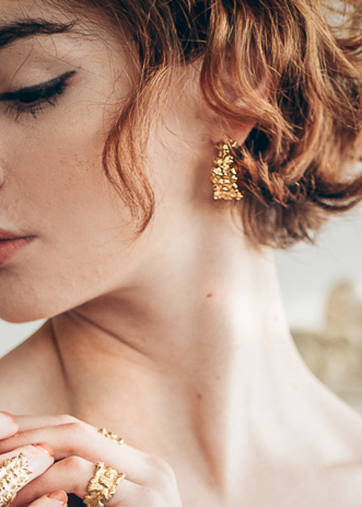 Profile of  girl, wearing a gold jewellery from 3rd Floor's Hippolyta Collection