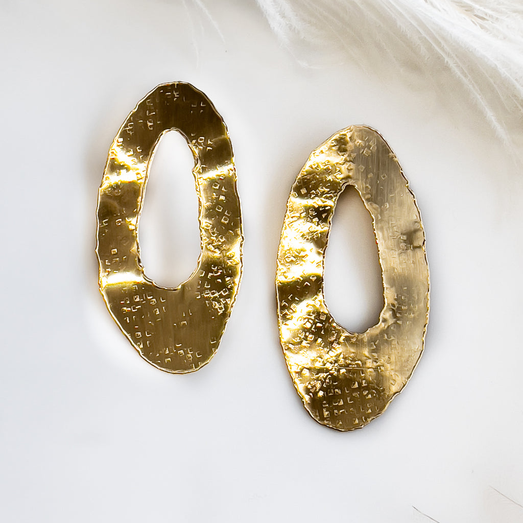 pair of the Toma handmade earrings made of gold plated hammered brass