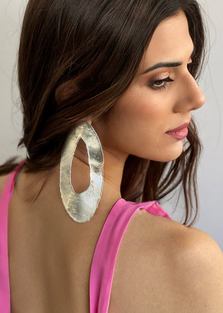 brunette  with a pink dress fashioning the TOma handmade earring