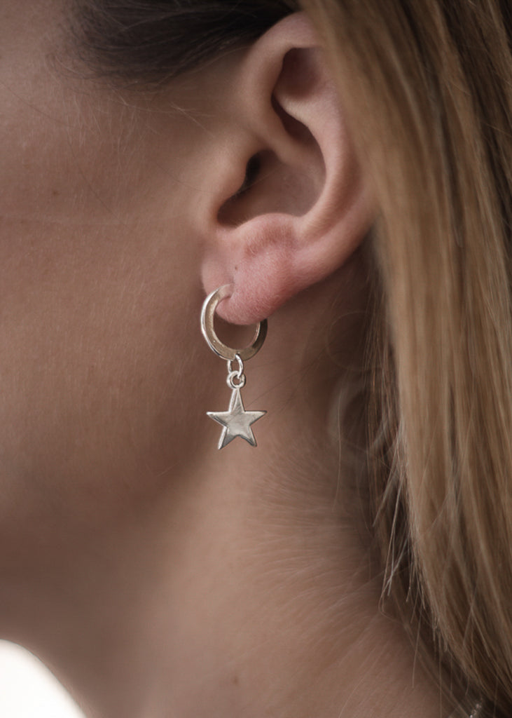blonde girl with Vega. Handmade, silver plated silver, hoop earrings, with a small dangling star