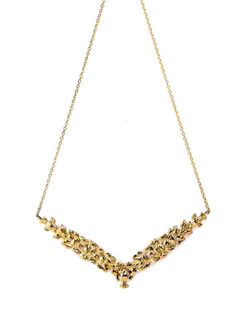 Gold, V shaped necklace with embossed flower pattern. Hyppolyta necklace by 3rd Floor Jewellery