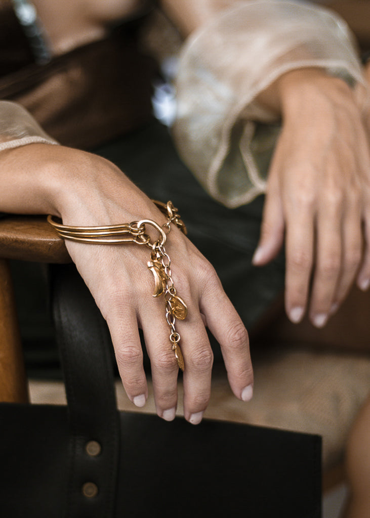 woman with Handmade, gold plated brass, bracelet by 3rd Floor Handmade Jewellery