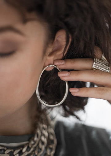 woman wearing loop earrings silver