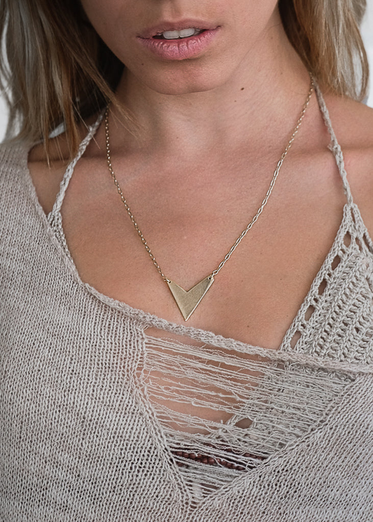 blonde girl with arrow necklace 