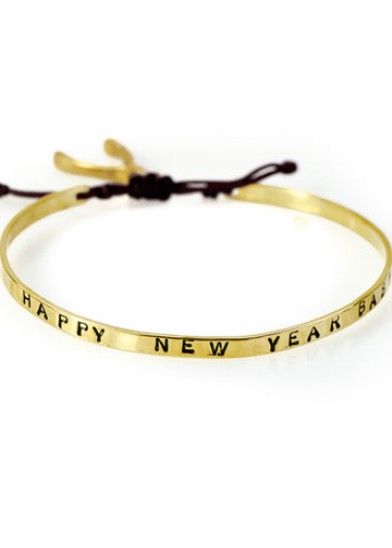 Handmade, gold plated brass, adjustable charm bracelet, stamped with the phrase Happy New Year Baby