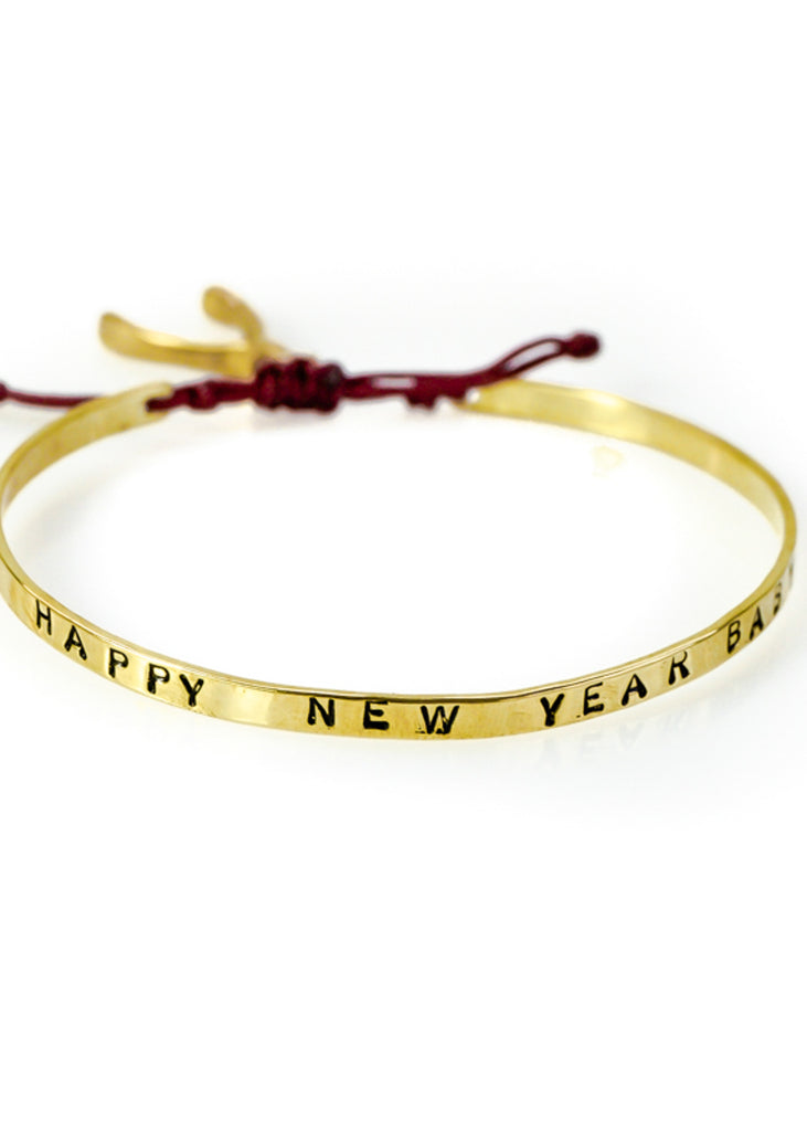 Handmade, gold plated brass, adjustable charm bracelet, stamped with phrase Happy New Year Baby 