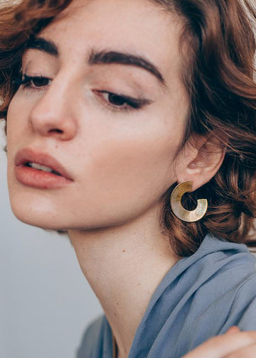 model,wearing,Half ripple, shaped, handmade, gold earring, by 3rd Floor Handmade Jewellery