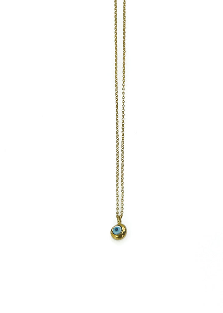 Photo of a gold, thin chain necklace, festooned with a small, evil eye