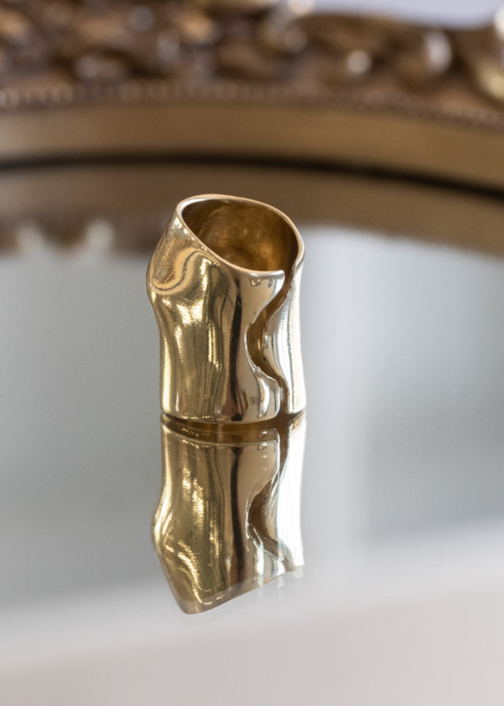 Back side of a gold, Punch, chevalier ring, placed on a mirror. Design by Eleni Papastavrou