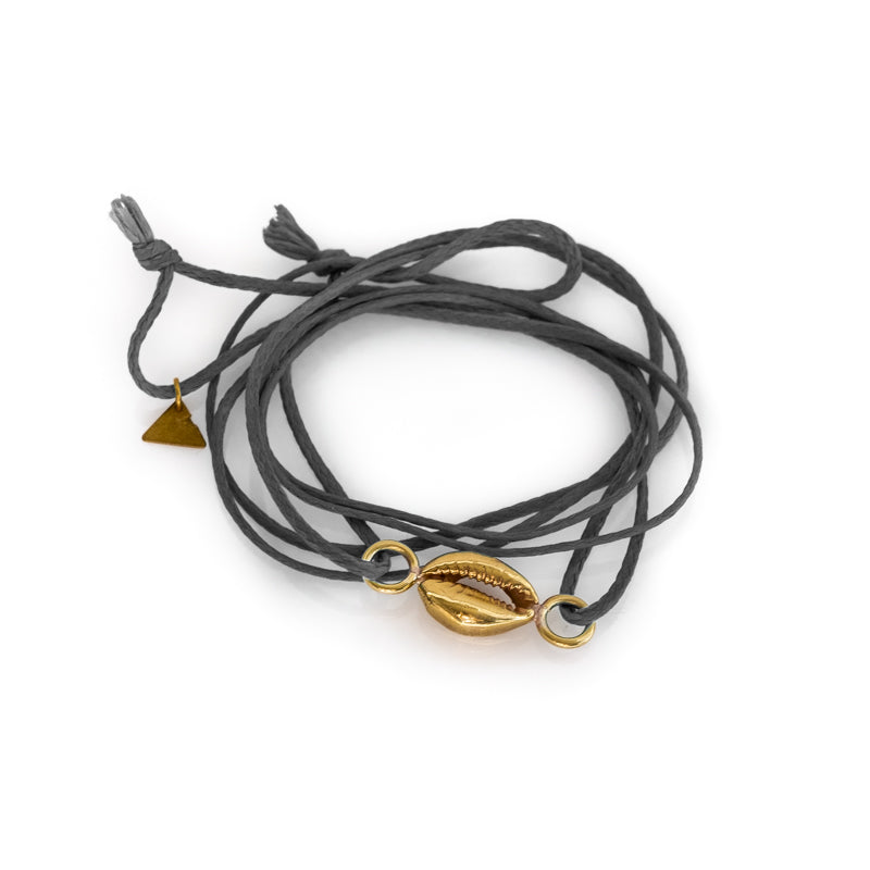 Gold colored seashell bracelet, with a double, grey colored cord. By 3rd Floor Lab