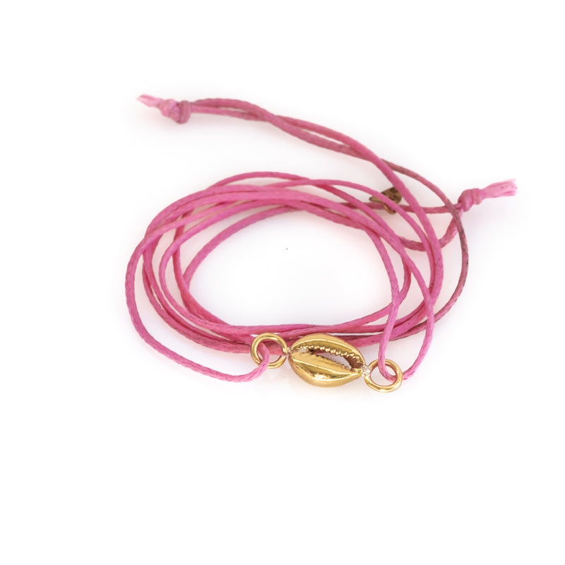 Pink colored, waxed cord wristlet with a gold colored seashell. By 3rd Floor Lab