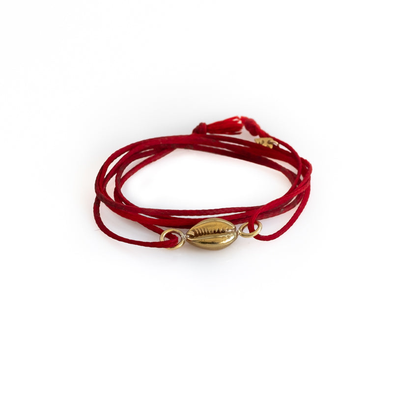 Red, double, cord bracelet with a center, gold colored seashell