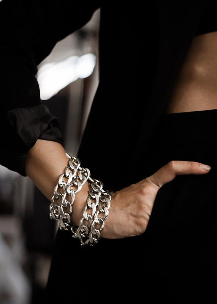 Woman's hands, she is wearing a Tetra, handmade, silver plated brass, chain bracelet.
