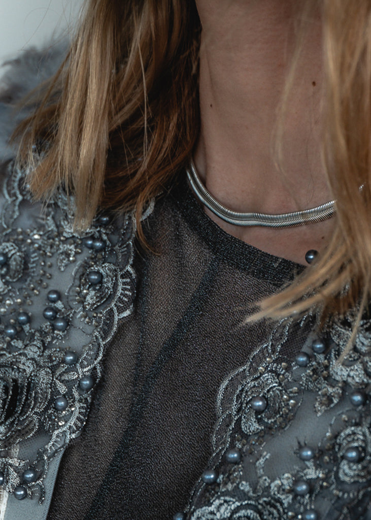 close-up woman with Marisol. Silver, herringbone chain, choker necklace. 