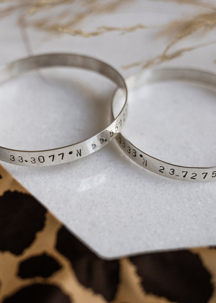 photo of 2 Marco Polo handmade bangle bracelets stamped with your choice of longitude and latitude coordinates - By 3rd Floor 