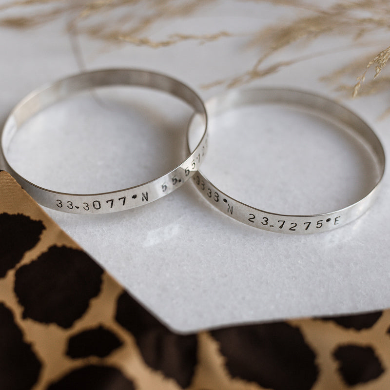 photo of 2 Marco Polo handmade bangle bracelets stamped with your choice of longitude and latitude coordinates 