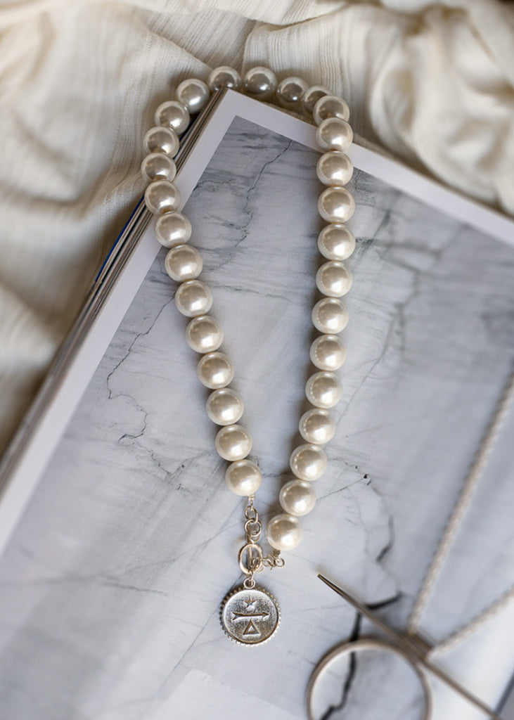 Big pearl, single string necklace, with a sterling silver, embossed plaque on the buckle. By 3rd Floor Handmade Jewellery