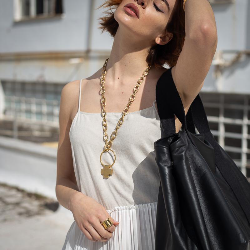 model walking with white dress, and 3rd-floor handmade And necklace, brass-gold