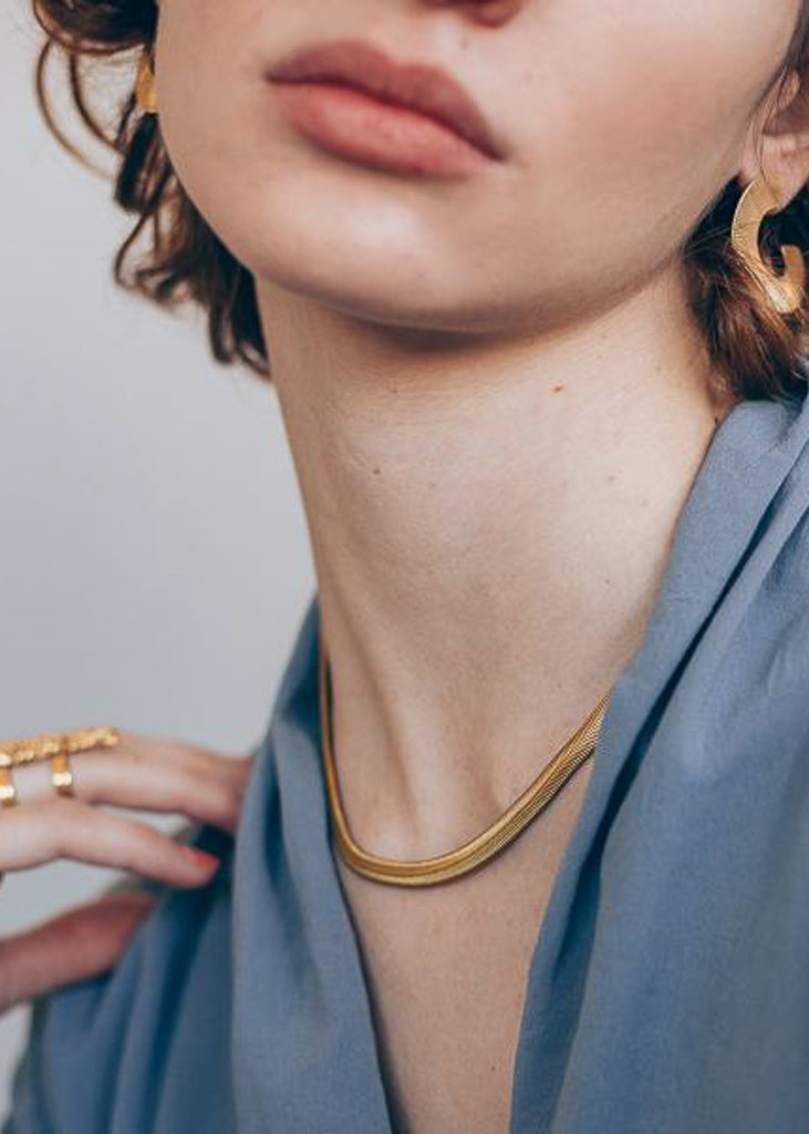 woman with Marisol,Gold, herringbone chain, choker necklace. Designed by 3rd Floor Lab
