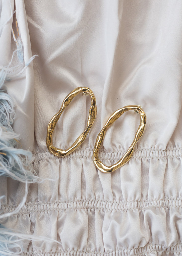 Gold, oval shaped, loop earrings. Designed by 3rd Floor Handmade Jewellery