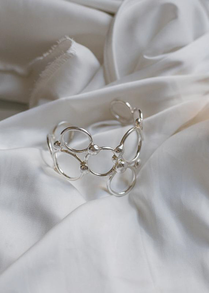 photo of pendulum, silver bracelet