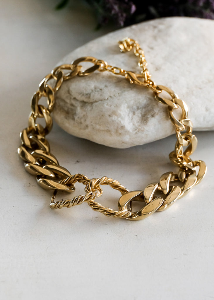 Gold, chunky chain necklace, with two, interlocked, rope links in the center.